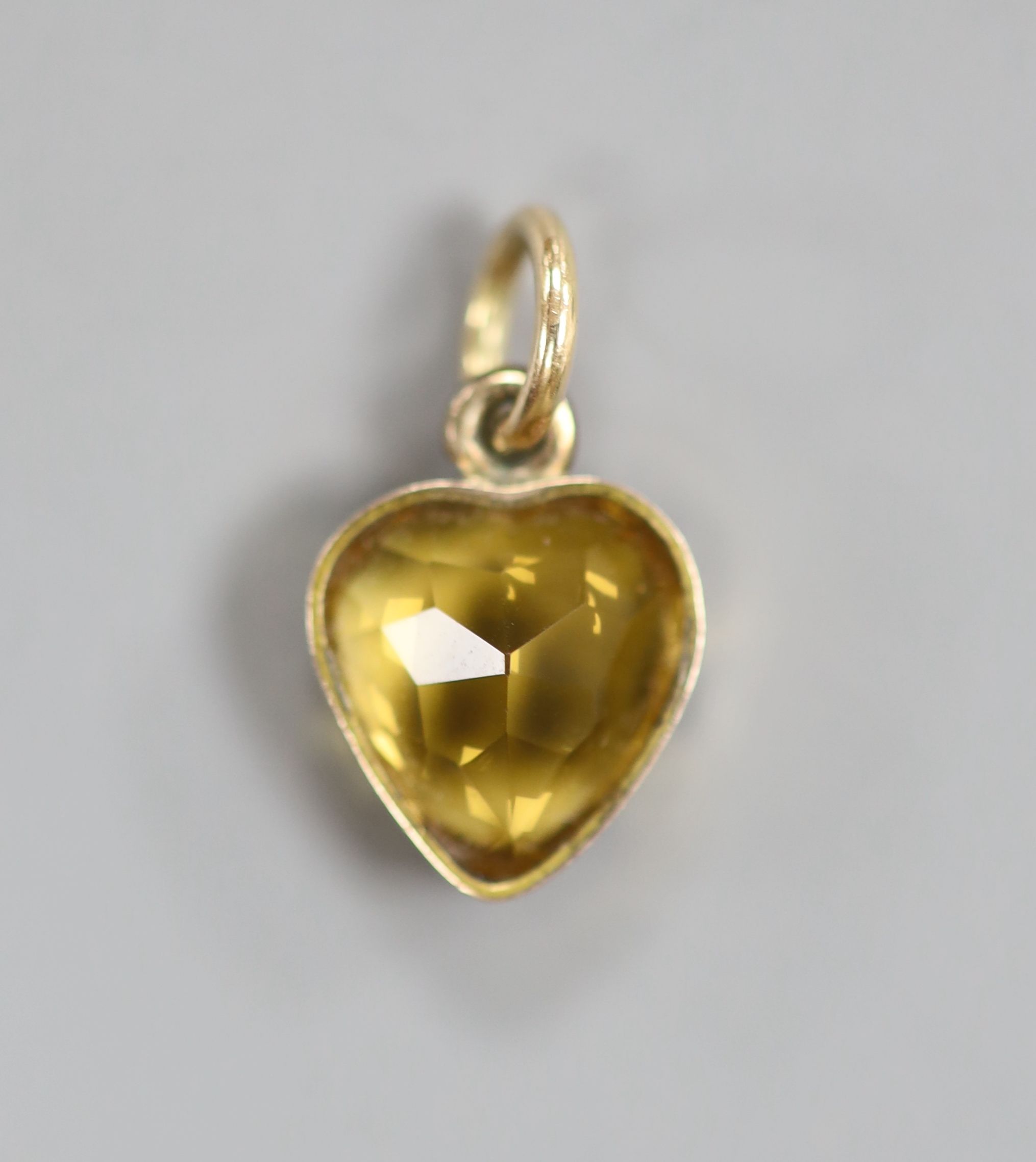 A yellow metal and heart shape citrine pendant, 10mm and pair of matching ear studs(no butterflies), gross 3.6 grams.